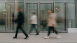 blurry people hurried and busy in the city of chicago, walking around in front of a building